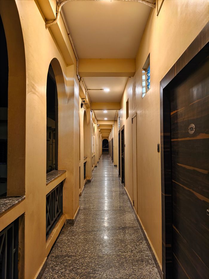 A beautifully lit indoor corridor with arches, offering a warm and classic ambiance.